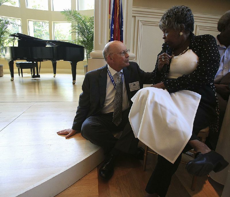 Annie Abrams chats with Little Rock School District Superintendent Baker Kurrus on Tuesday during his appearance at a Political Animals Club gathering in Little Rock.