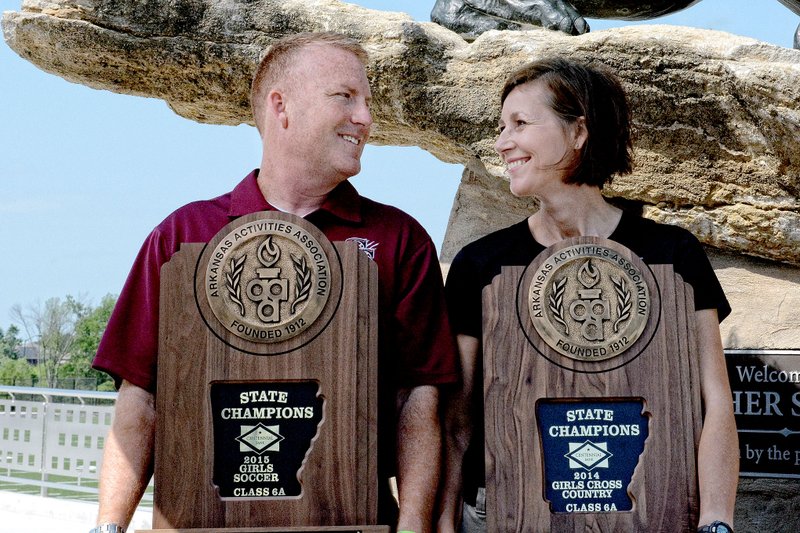 Bud Sullins/Special to the Herald-Leader Siloam Springs coaches &#8212; and husband and wife &#8212; Chuck and Sharon Jones both won state championship and state runner-up trophies this school year in their respective sports. Sharon led the Lady Panthers cross country team to a 6A state title, while the Panthers finished as state runner-up. Chuck led the Siloam Springs girls soccer team to a state title and the Panthers finished state runner-up.