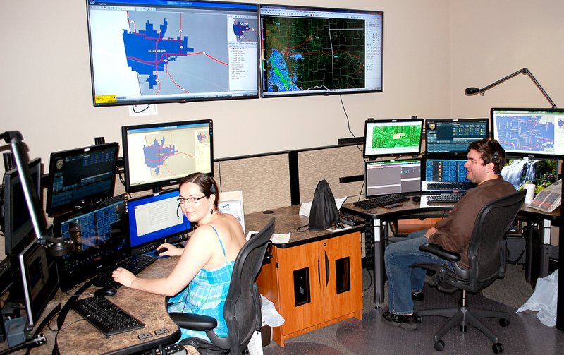 Jeff Della Rosa/Special to The Herald-Leader Siloam Springs 911 dispatchers work at their stations in the police department at Mount Olive Street and U.S. Highway 412. Dispatchers have worked to support police officers and let them know about emergencies in which to respond.