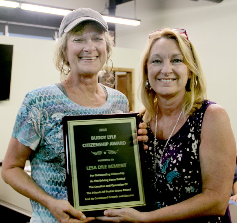 LYNN KUTTER ENTERPRISE-LEADER Gina Lyle-Bailey, a member of Prairie Grove City Council, right, presents the Buddy Lyle Citizenship Award to her sister, Lesa Lyle Bement. Both are daughters of Buddy Lyle, who passed away a year ago.