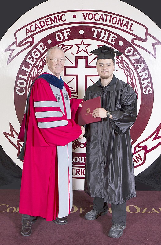 Photograph submitted Wheatley received a diploma from College of the Ozarks President Jerry C. Davis.