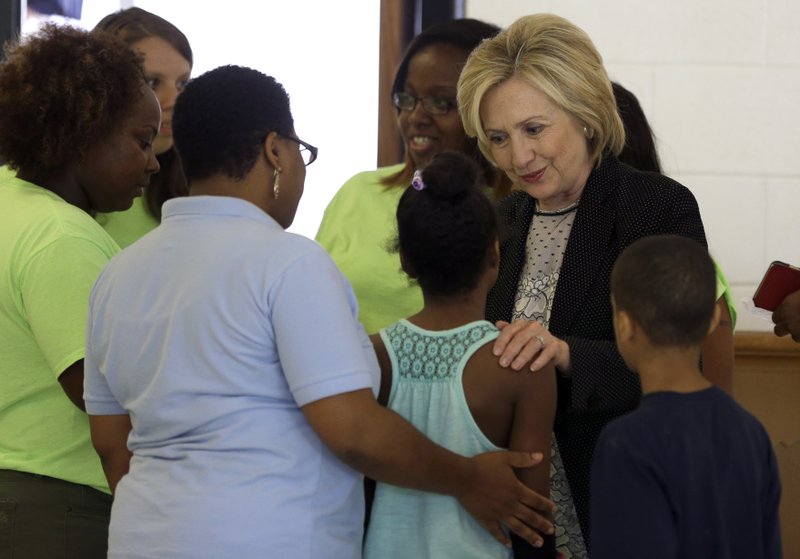 Democratic presidential candidate Hillary Rodham Clinton greets children participating in a summer camp before delivering remarks during a campaign stop at Christ the King United Church of Christ, Tuesday, June 23, 2015, in Florissant, Mo.