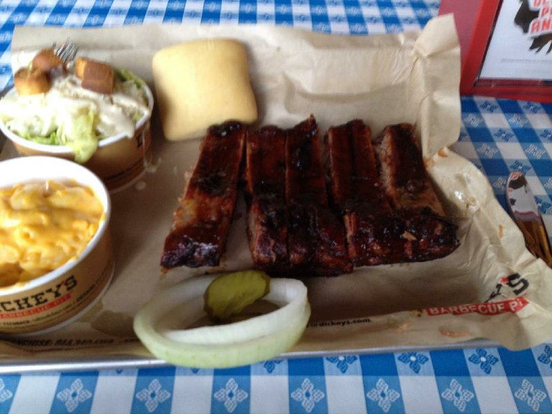 The Rib Plate at Dickey’s Barbecue Pit features five bones and two sides (here, Caesar salad and mac & cheese).
