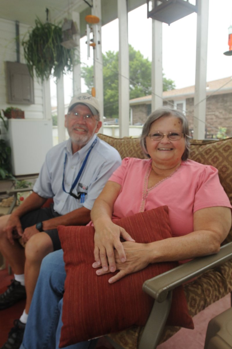 Elaine Holloway, 2015 fish-story champion, sits with her husband, Mike, in their screen room at their home on Perry Road in Rogers. Their grandkids call it the “scream room” Elaine said. Elaine won a selection of fishing lures for winning the fish story contest.