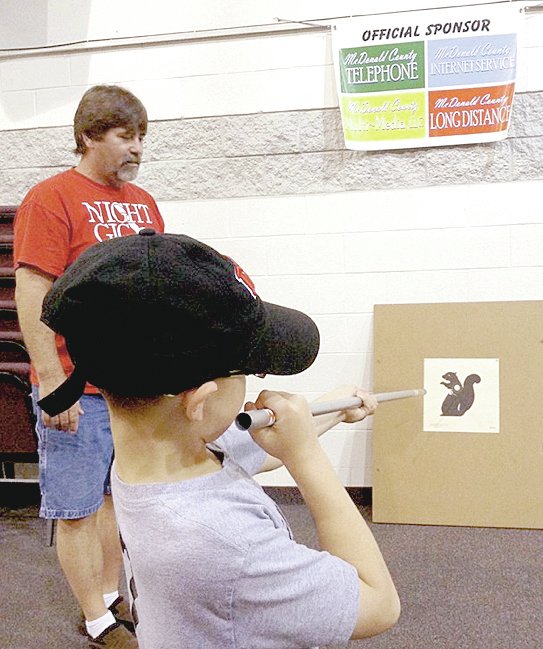 &#8216;I think I can get it&#8217; says Jette Akin, 7, of Anderson, as he takes aim with a homemade blowgun during a recent Young Outdoorsmen United seminar. Area youth learned how to make, shoot, and be safe with the primitive hunting tool.