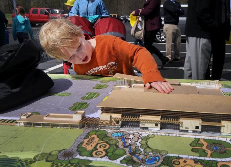 Miller Rawn, 5, takes a look at a model of the Amazeum’s discovery cente during the groundbreaking in April 2014 in Bentonville.