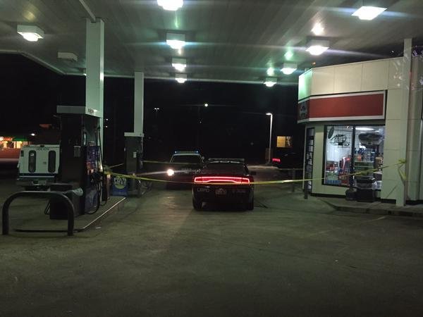 Little Rock police vehicles sit outside an Exxon Wednesday night after it was robbed by two gunmen.