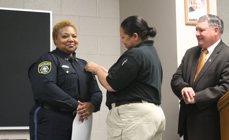Toni Rose is honored with a new badge recognizing her promotion to captain of security and housing.