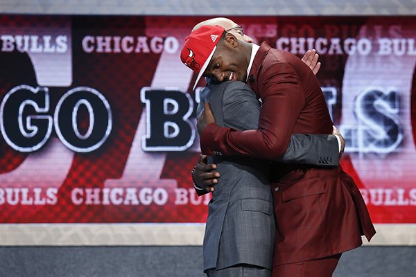 Bobby Portis, right, hugs NBA Commissioner Adam Silver after being selected 22nd overall by the Chicago Bulls during the NBA basketball draft, Thursday, June 25, 2015, in New York. (AP Photo/Kathy Willens)