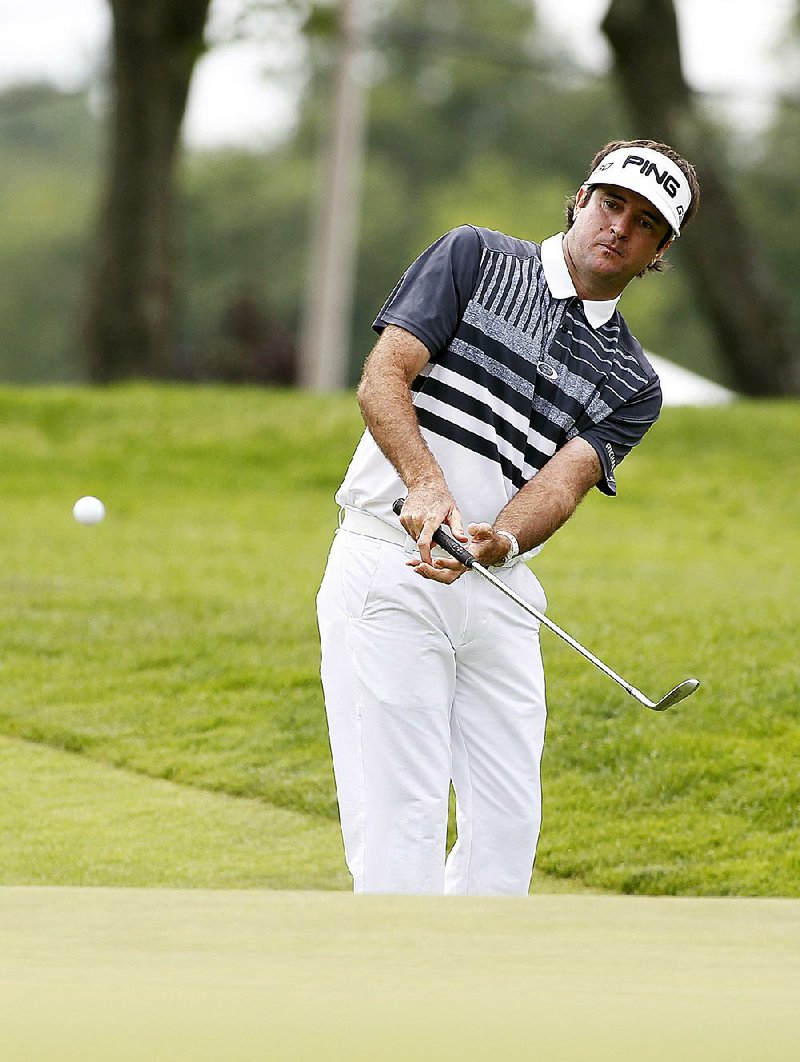Bubba Watson chips to the ninth green during the first round of the Travelers Championship on Thursday in Cromwell, Conn. Watson made a birdie on the hole on his way to a first-round 62. 
