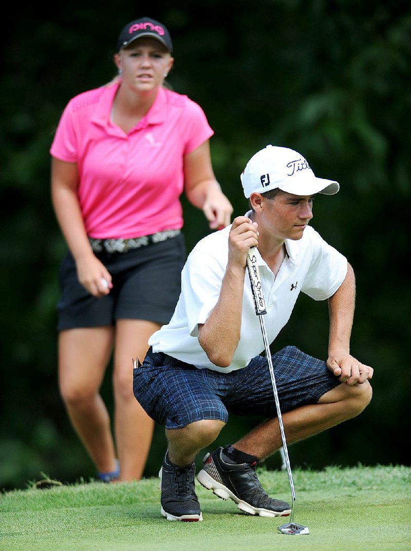 Noah Goodwin (right) of Cornith, Texas, and Hailee Cooper of Montgomery, Texas, line up their putts on the 16th green during the Stacy Lewis Junior All-Star Invitational at Blessings Golf Club in Johnson. Goodwin won the boys individual title and Cooper won the girls individual title. 