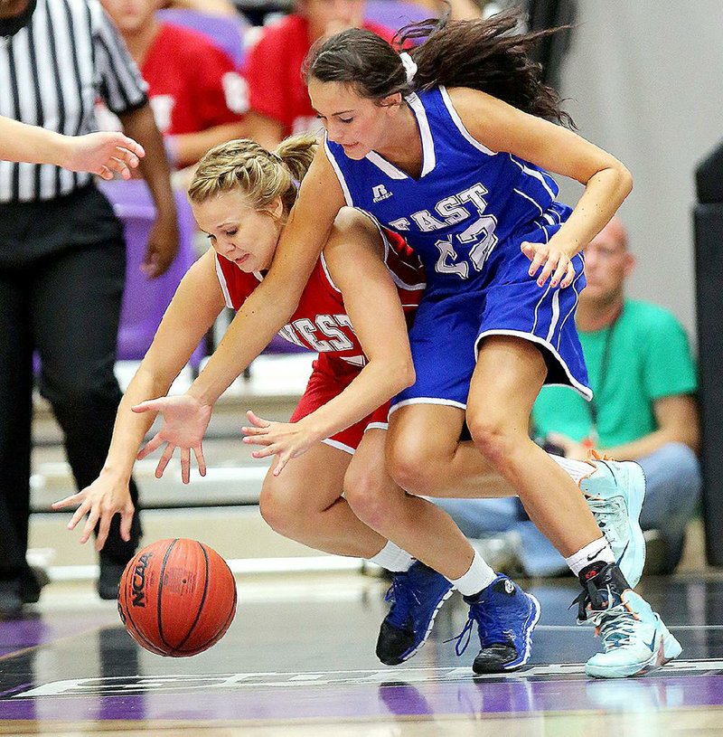 The West’s Adriana Walston of Dierks (left) and the East’s Bailey Zimmerman of Wonderview chase down a loose ball during Thursday’s all-star girls basketball game at the Farris Center in Conway. The East pulled away for an 86-71 victory. 