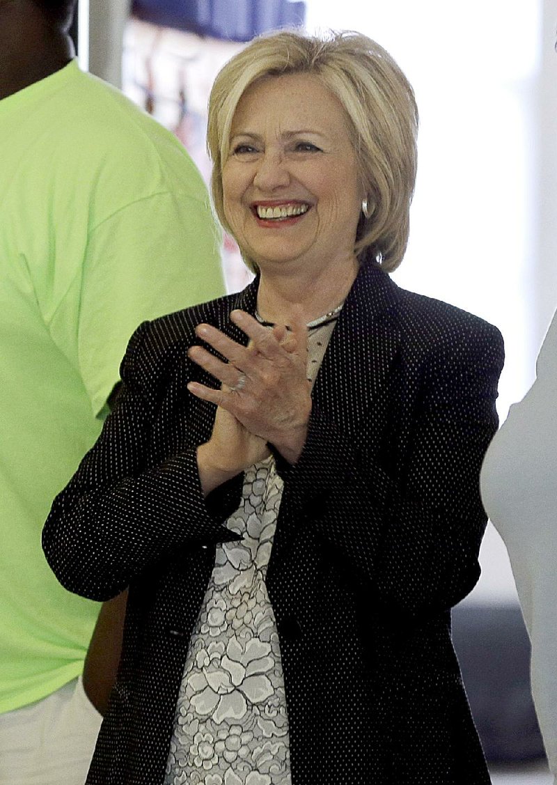 Democratic presidential candidate Hillary Rodham Clinton smiles as she watches children participate in a summer camp before delivering remarks during a campaign stop at Christ the King United Church of Christ, Tuesday, June 23, 2015, in Florissant, Mo. 