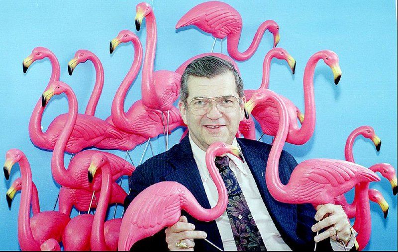 Artist Don Featherstone, creator of the famous plastic pink flamingo, poses with a few of the popular plastic birds in 1996. 