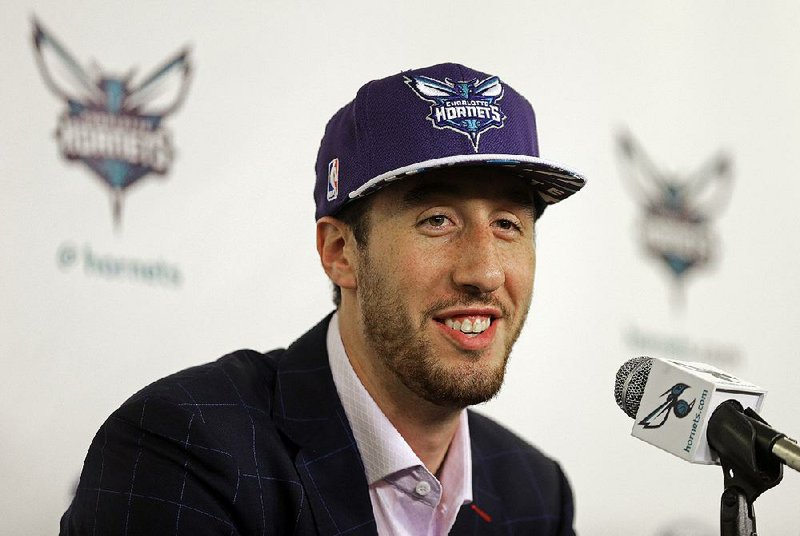 Charlotte Hornets first round draft choice Frank Kaminsky smiles as he listens to a question during an NBA basketball new conference in Charlotte, N.C., Friday, June 26, 2015.