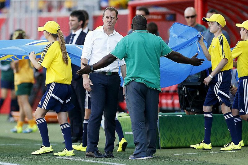 Nigeria head coach Edwin Ikon, center right, gestures to Australia head coach Alen Stajcic after an abrupt end to their match during the FIFA Women's World Cup in Winnipeg, Manitoba, Friday, June 12, 2015. 