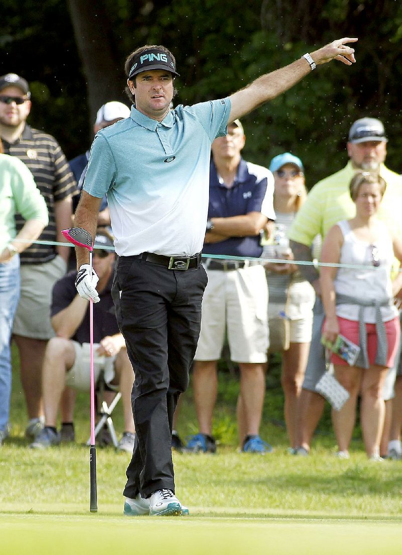 Bubba Watson points to the gallery that his ball is going left after his tee shot on the 13th hole during the second round of the Travelers Championship golf tournament, Friday, June 26, 2015, in Cromwell, Conn. 