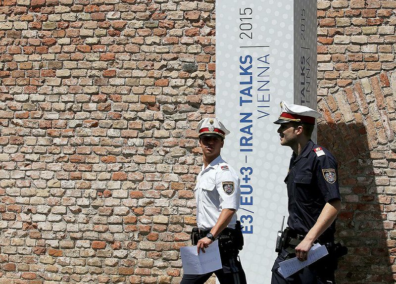 Police officers on Friday pass Vienna’s Palais Coburg, where nuclear talks with Iran are being held. 