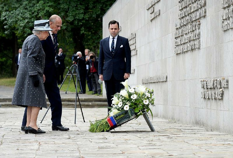 Britain’s Queen Elizabeth II and Prince Philip lay a wreath during their visit Friday to the former Nazi concentration camp Bergen-Belsen in Germany. 