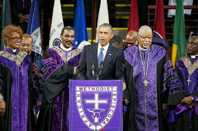 President Barack Obama leads the church in singing “Amazing Grace” in capping his eulogy Friday for the Rev. Clementa Pinckney in Charleston, S.C. 