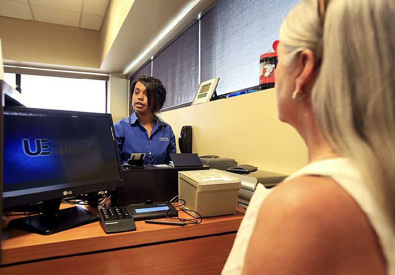 Esperanza Rodriguez (left) enrolls Leila Dockery of Little Rock in the PreCheck program Friday at a new enrollment center at Bill and Hillary Clinton National Airport/Adams Field. 
