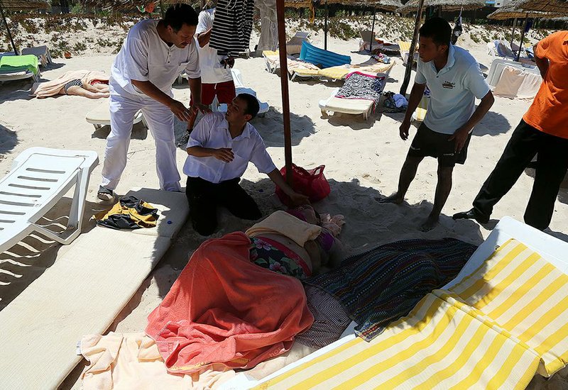 An injured person is treated on a beach Friday in Sousse, Tunisia. 