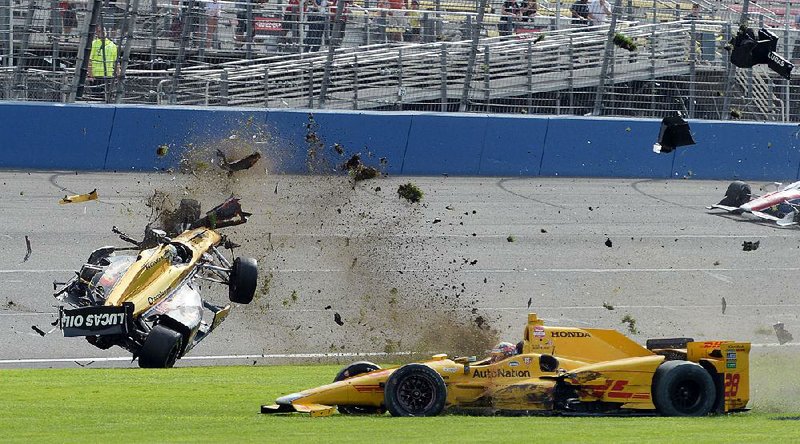 Ryan Briscoe (left) was one lap away from a top-10 finish in Saturday’s IndyCar race at Auto Club Speedway, but his car was sent soaring through the air after being hit Ryan Hunter-Reay. The wreck caused several drivers to complain about the style of pack racing at oval-shaped race tracks.