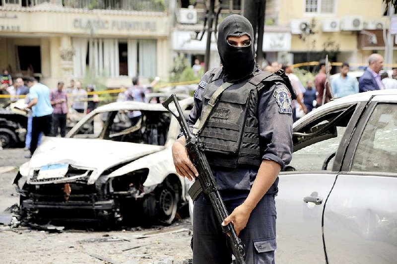 An Egyptian policeman stands guard Monday after a bomb attack by Islamic militants targeted the convoy of Egypt’s Prosecutor General Hisham Barakat in the Heliopolis district of Cairo. Barakat was killed in the attack.