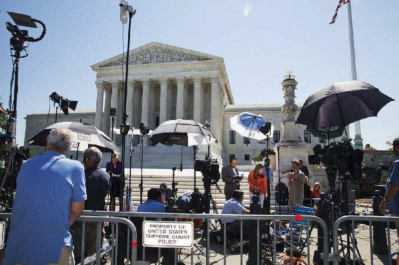News stations report as the Supreme Court decisions are released Monday in Washington. The court upheld the use of midazolam, a drug used in lethal injections by Oklahoma, Florida, Ohio and Arizona.