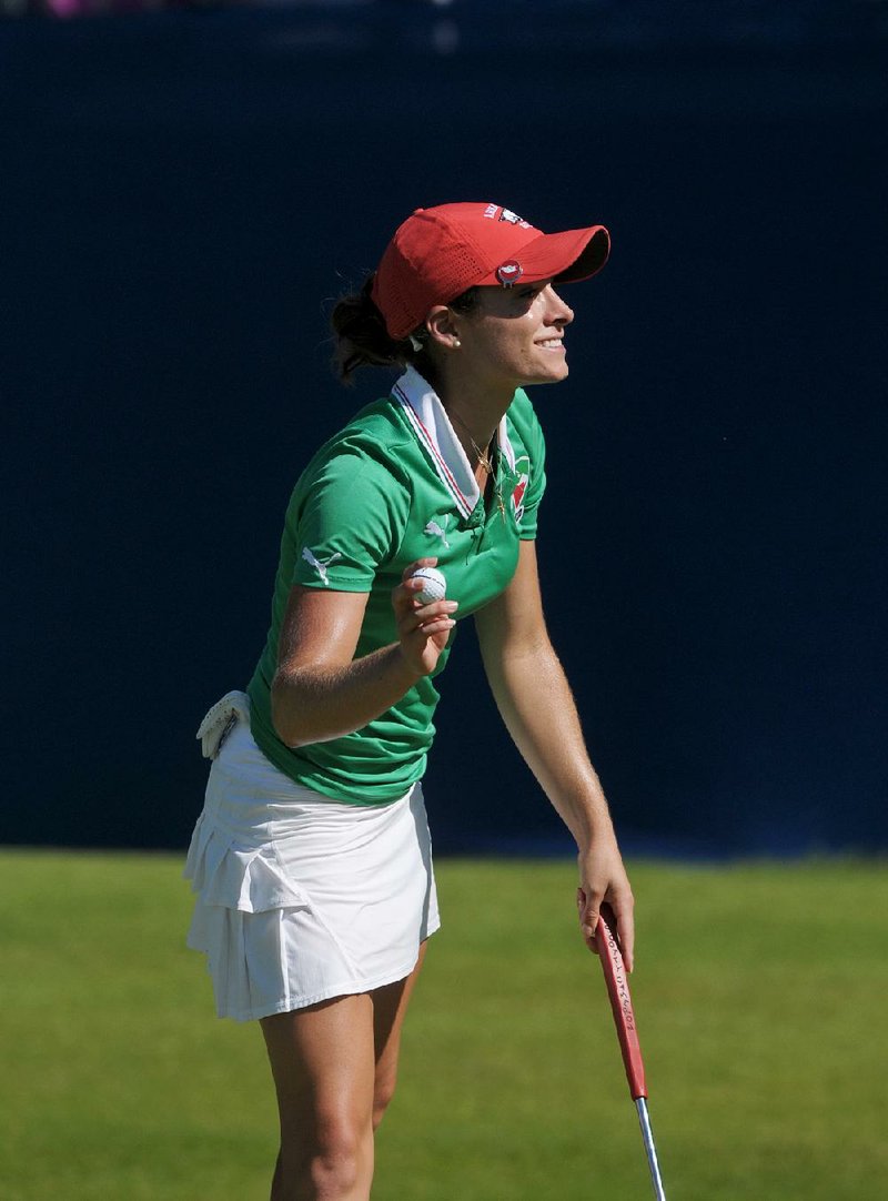 Arkansas Razorbacks golfer Gaby Lopez waves to the gallery after completing her round Sunday at Pinnacle Country Club in Rogers.