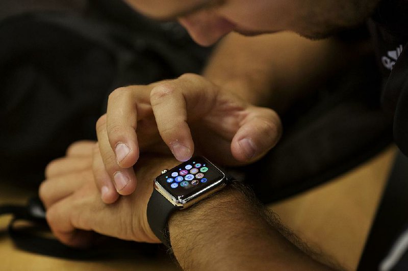 An employee sets up an Apple Watch for a customer at an Apple Inc. store in New York.