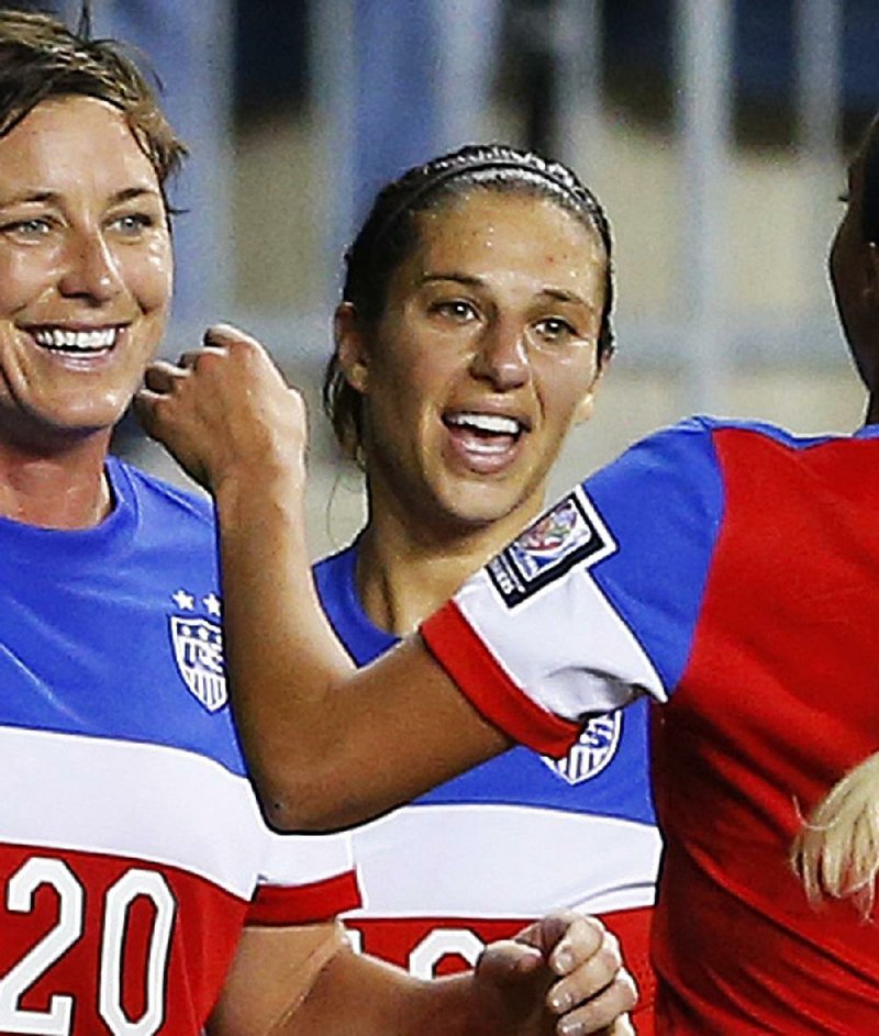 Carli Lloyd is shown with her United States teammates in this October 2014 file photo.