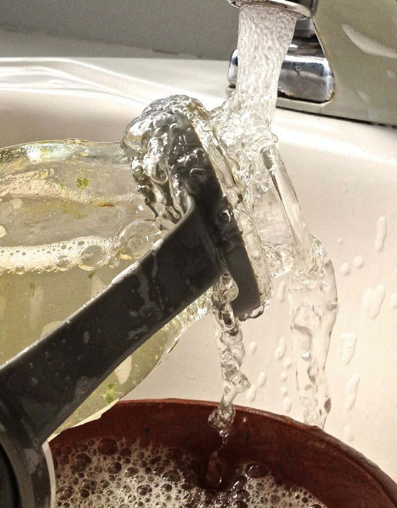 Hot water cascades over dishes.