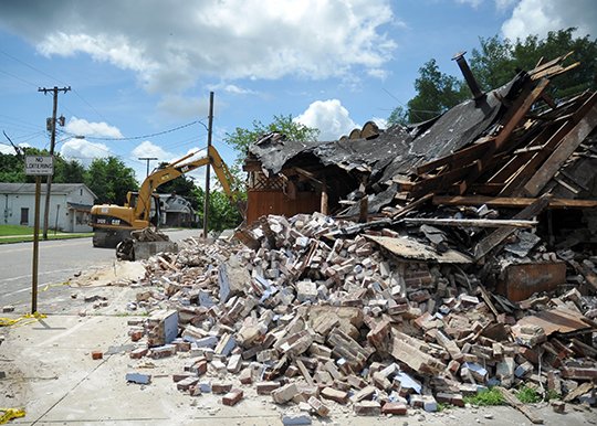 The Sentinel-Record/Mara Kuhn TOWN TALK GONE: Charlie Fanning, owner of Fanning Construction of Hot Springs, worked Saturday to tear down the former Dewey's Town Talk BBQ, 200 Pleasant St. City officials said the deteriorated condition of the building was affecting its structural integrity.