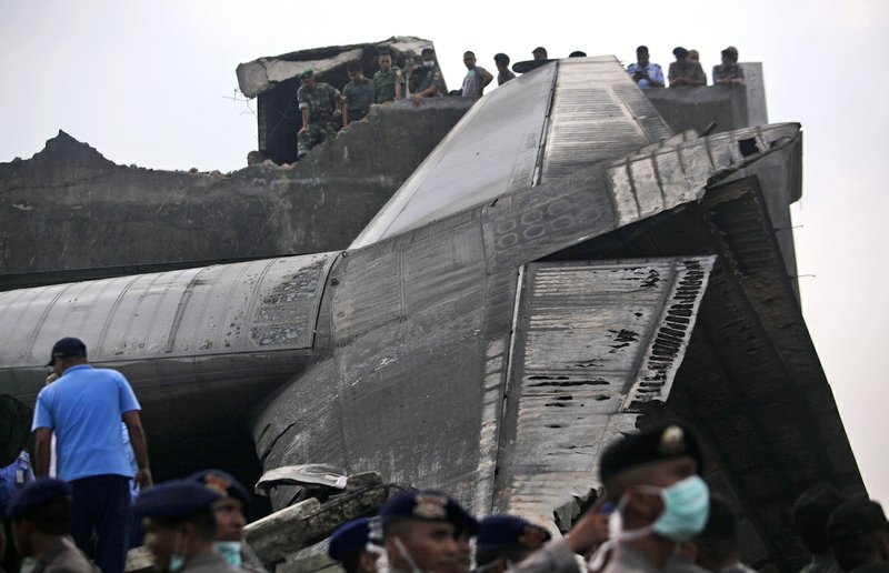 Indonesian military personnel search for victims at the site where an air force cargo plane crashed in Medan, North Sumatra, Indonesia, Tuesday, June 30, 2015. The Hercules C-130 plane has crashed into a residential neighborhood in the country's third-largest city Medan.