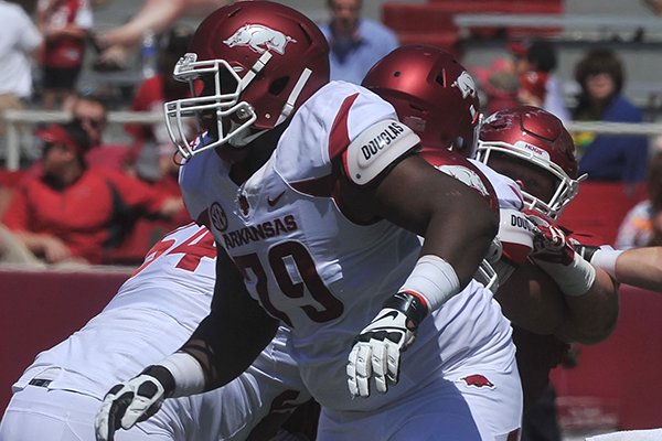 Arkansas offensive lineman Jalen Merrick blocks during the Razorbacks' Red-White Game on Saturday, April 25, 2015, at Razorback Stadium in Fayetteville.