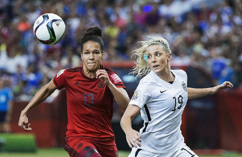 United States’ Julie Johnston (19) challenges Germany’s Celia Sasic during the second half of a semifinal in the Women’s World Cup soccer tournament Tuesday in Montreal, Canada. The United States won 2-0. 