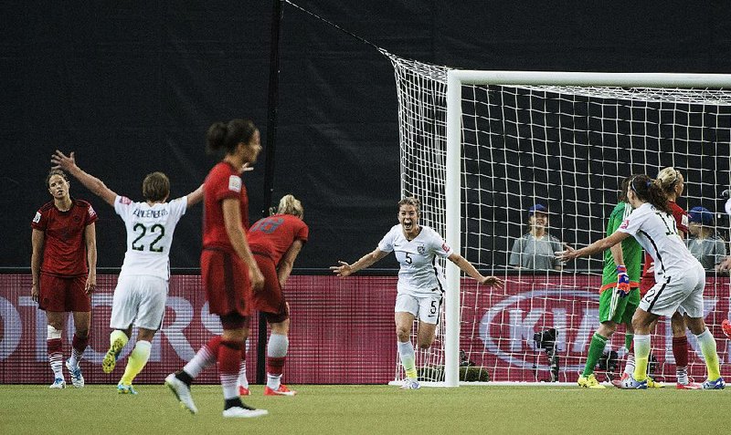 Kelley O’Hara (5) of the United States rushes toward teammate Meghan Klingenberg after scoring a goal during the second half of the American’s 2-0 victory over Germany in Tuesday night’s semifinal match of the Women’s World Cup at Montreal.