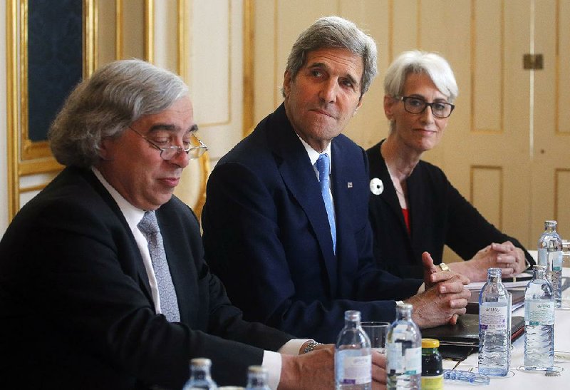 Energy Secretary Ernest Moniz (left), Secretary of State John Kerry and Wendy Sherman, undersecretary for political affairs, meet with Iranian officials Tuesday in Vienna, where negotiations on a nuclear agreement with Iran were extended for a week hours before Tuesday’s deadline for completing the talks expired.