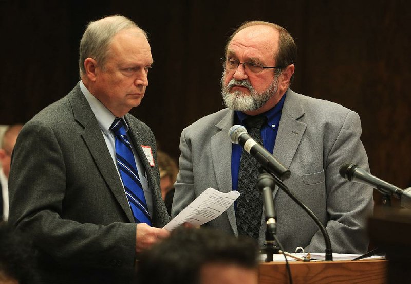 In this file photo Bill Goff (left) and Jerry Guess, CFO and Superintendent respectively of the Pulaski County Special School District, answer questions during a meeting of the state Board of Education concerning the district's fiscal distress. 