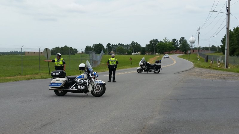 Police officers direct traffic away from Remount Road Wednesday while authorities investigated a suspicious package found to have the components of a bomb.