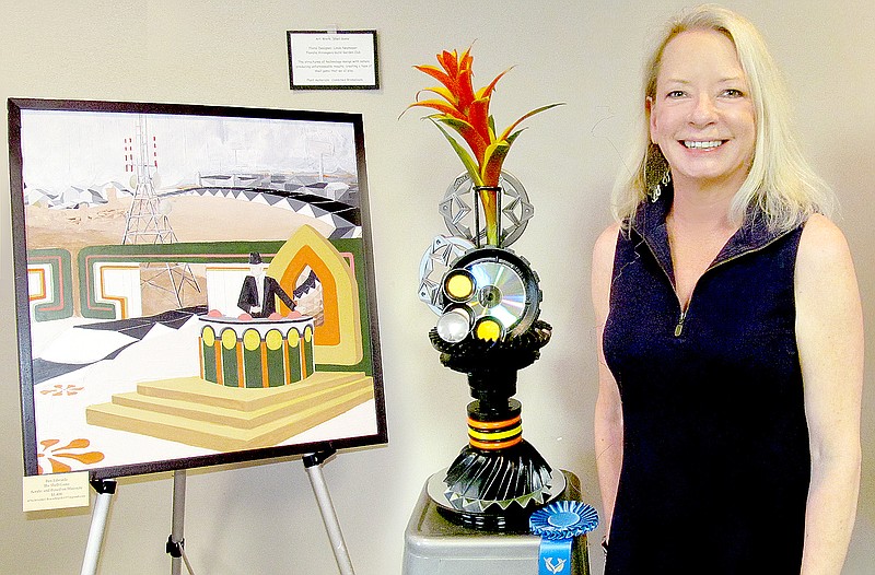 Submitted Linda Neymeyer of Bella Vista, chairman of the &#8220;Duets in Bloom&#8221; exhibit, is pictured with her first prize-winning interpretation of &#8220;Shell Game&#8221; by Ben Edwards.