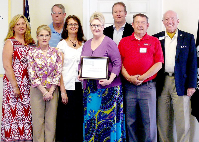 Submitted Joe Gratzl, second from right, AARP Driver Safety District Insurance, presented Village Insurance with the inaugural &#8220;Top State Host&#8221; award for its outstanding support in 2014. Village Insurance associates at the presentation were Tricia Alexander, Linda Howard, Mark Inman, Casandra Slichter, Janie Combrink, Doug Bachman, Village Insurance president. Bella Vista Mayor Peter Christie, right, also attended the presentation.