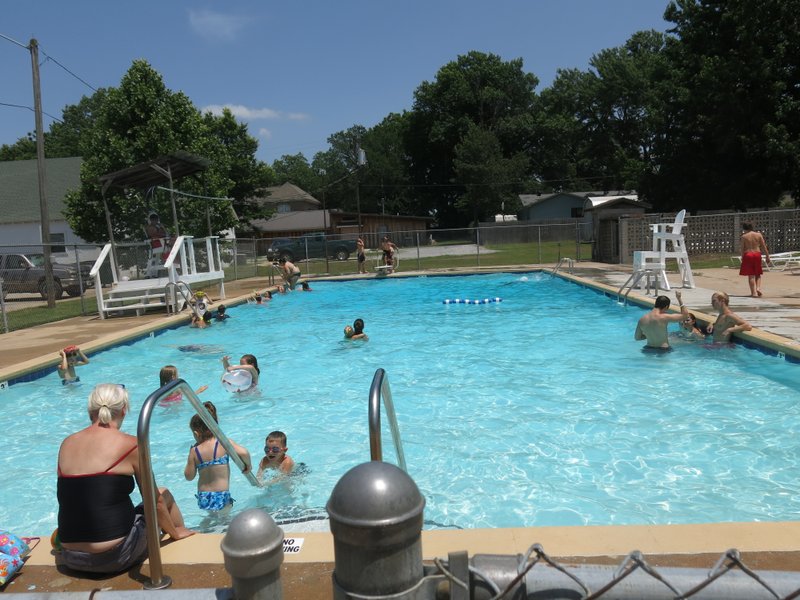 Photo by Susan Holland Swimmers young and old are enjoying the Gravette pool, which opened June 16. The pool is open Monday through Saturday 12 noon to 6 p.m. and Sunday 1 p.m. to 5 p.m.