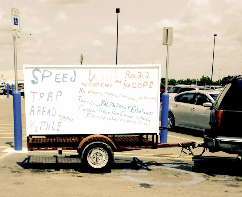 James Little has been seen hauling this sign behind his vehicle. It warns fellow motorists of Little&#8217;s perception of a possible speed trap in the town of Watts, Okla.