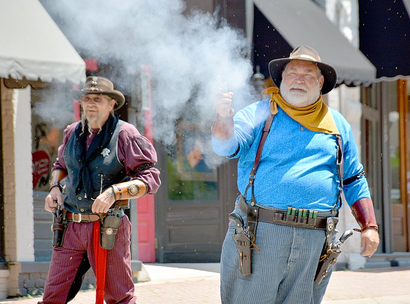 Janelle Jessen/Herald-Leader Outlaws &#8220;Blackwater Bruce&#8221; and &#8220;Ozarks Jim&#8221; shot at Texas Ranger &#8220;Circuit Rider,&#8221; in the middle of Broadway Street. The Arkansas Lead Slingers of Rogers held the shootout for the Heritage Festival on Saturday. The cowboy action shooting club holds events on the second Saturday and fourth Sunday of every month. More information is available at &#0010;www.arkansasleadslingers.org.