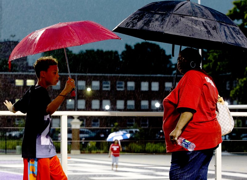 Melissa Sue Gerrits/Arkansas Democrat-Gazette Gloria Jackson, right, and her nephew Elijah Smith, 11, check out the field at Estes Stadium moments before the 2015 Arkansas High School Coaches Association All-Star Football game at UCA is canceled due to severe thunderstorms on Friday, June 26. The players and fans waited out several delays until the 7:45 p.m. call was made with lightning and thunder continuing over head. Jackson had traveled from Hot Springs to see her son Clifford Jackson III play in the tournament for West. Siloam Springs coach Bryan Ross was scheduled to coach for the East All-Stars.