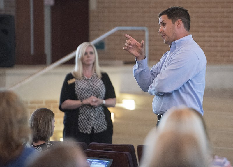 Joe Rollins, principal of Springdale’s School of Innovation, talks to parents Tuesday. The School District is applying for a charter for the school for the 2016-17 school year.