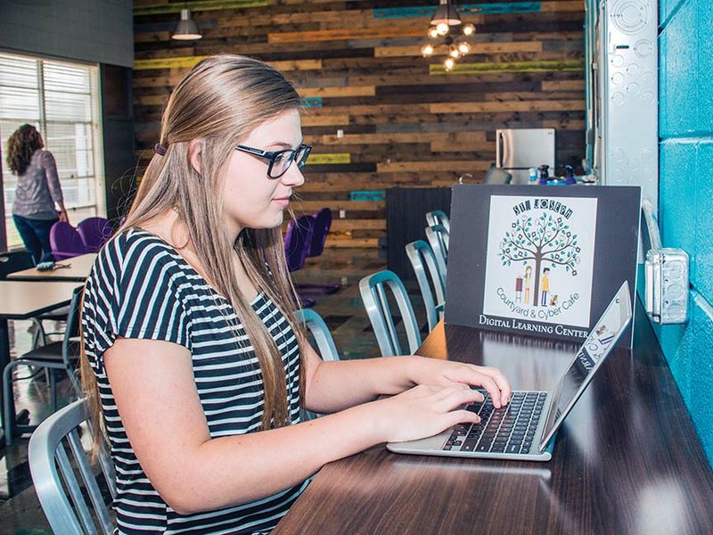 Student Emily Hambuchen works on a computer in the new Cyber Cafe at St. Joseph High School in Conway. Teachers and students came up with the idea to create the cafe, which includes 1879 Coffee and Co., by combining two seldom-used classrooms. As part of the project, a courtyard in the interior of the building was renovated to be used as an outdoor classroom and a place for students and faculty to enjoy.