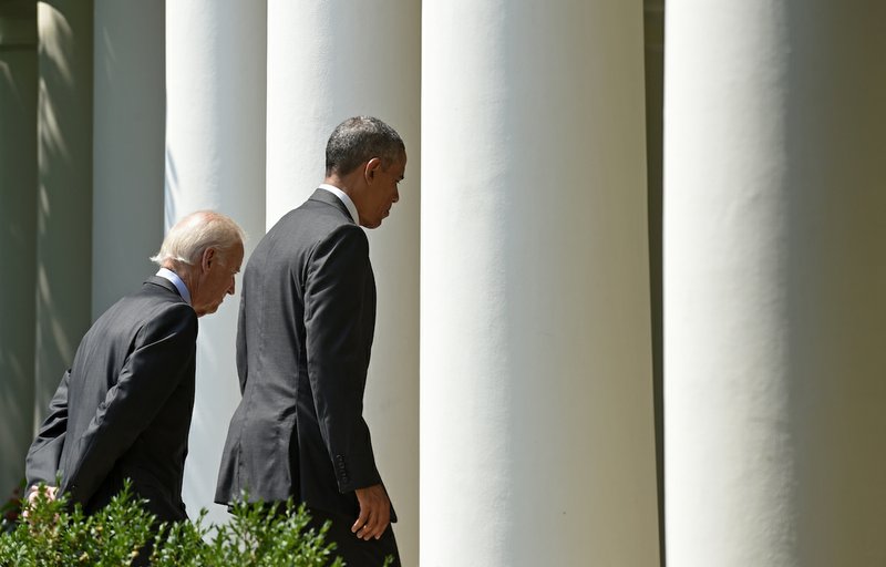 President Barack Obama and Vice President Joe Biden walk out of the Rose Garden of the White House in Washington, Wednesday, July 1, 2015, after the president announced that U.S. and Cuba have agreed to open embassies in each other's capitals, the biggest tangible step in the countries historic bid to restore ties after more than a half-century of hostilities.